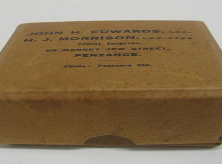 box cardboard with name and address of dentist on front